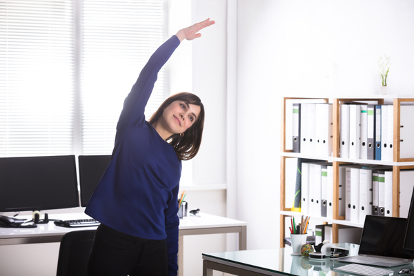 Woman stretching at work