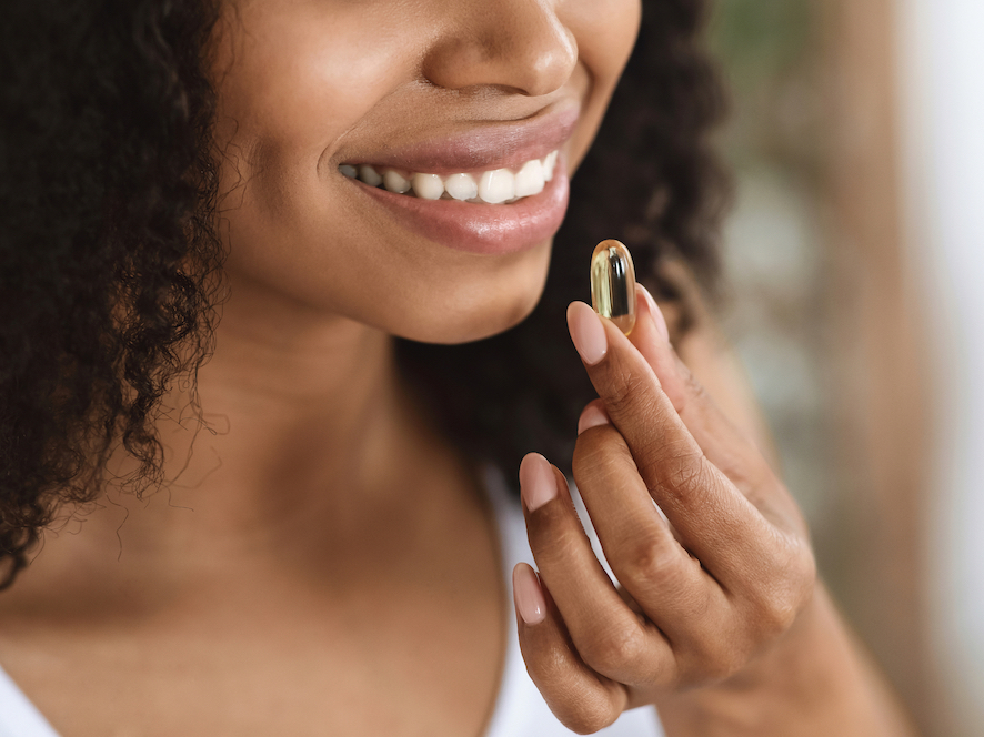 woman taking a supplement