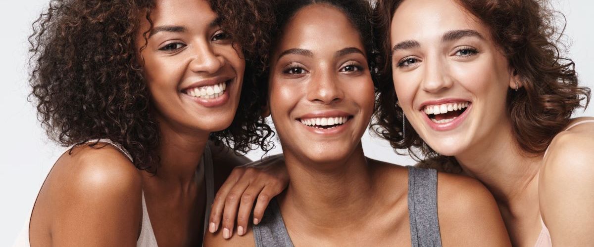 three women smiling beauty skincare concept