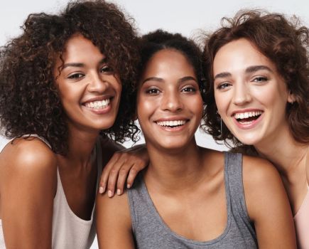 three women smiling beauty skincare concept