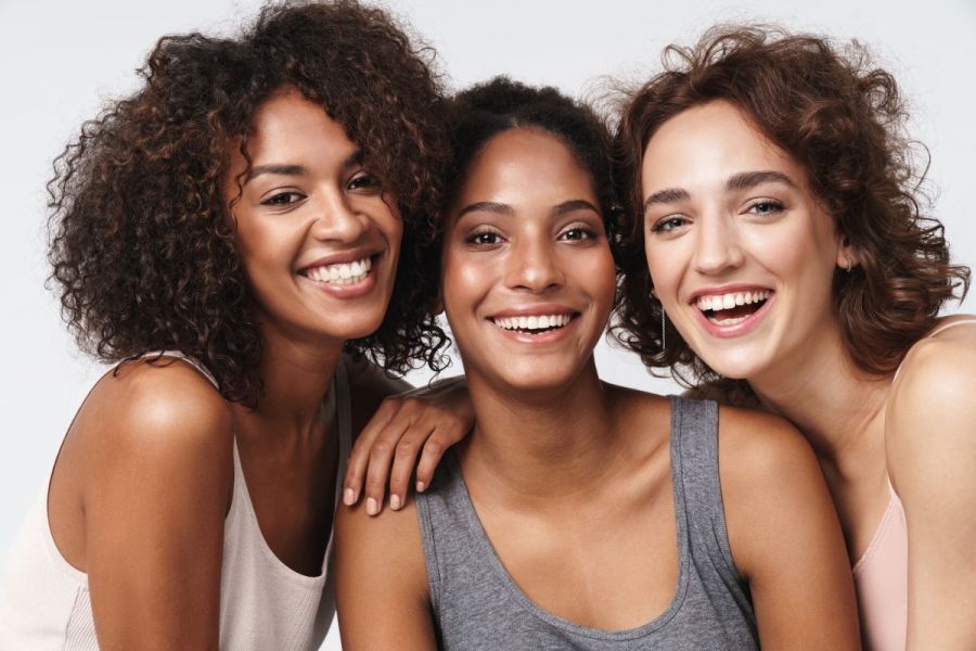 three women smiling beauty skincare concept
