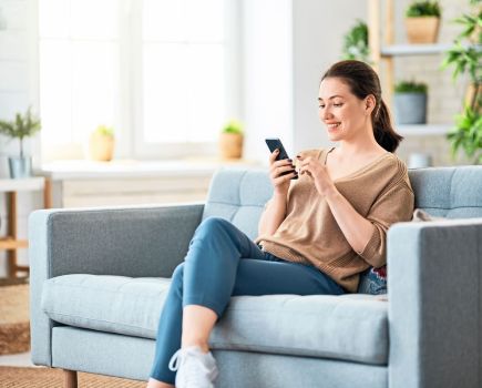 woman using phone for online health coaching