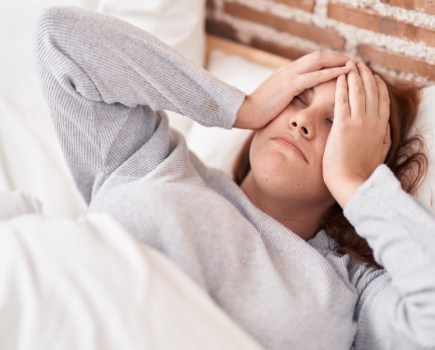 woman struggling to fall asleep sleep and weight loss concept