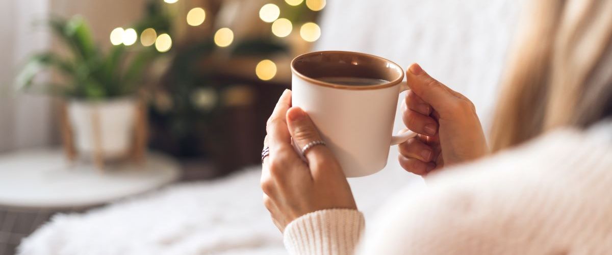 woman drinking hot drink winter cosy concept