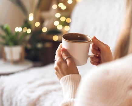 woman drinking hot drink winter cosy concept