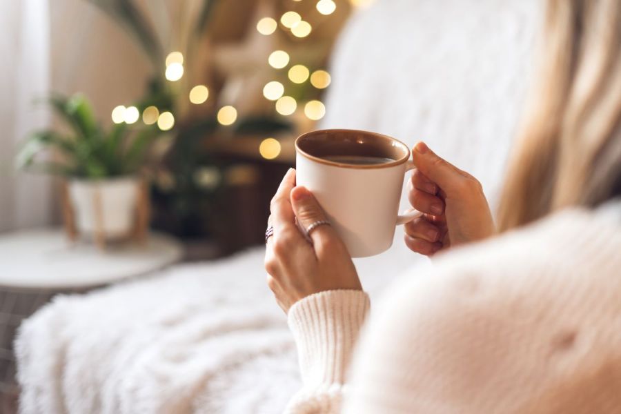 woman drinking hot drink winter cosy concept