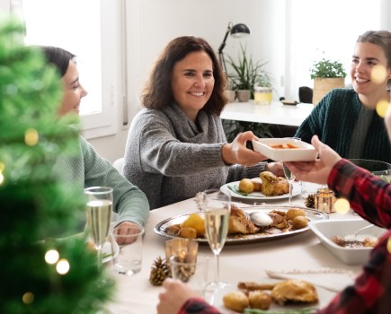 woman enjoying christmas dinner with her family
