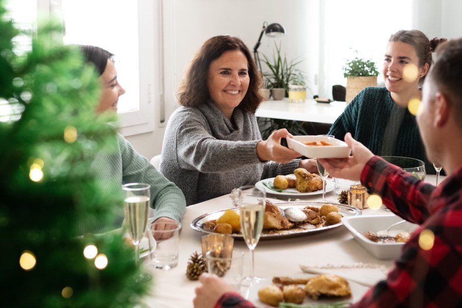 woman enjoying christmas dinner with her family
