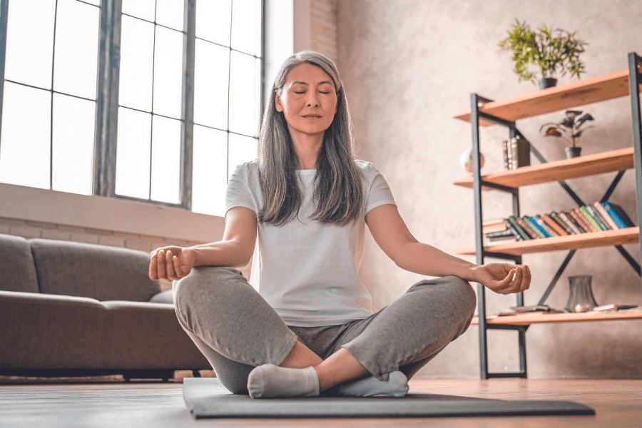 woman practicing mindfulness and self-compassion via yoga