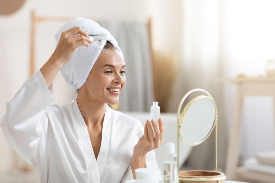 woman in bathroom skincare regime beauty wellbeing concept