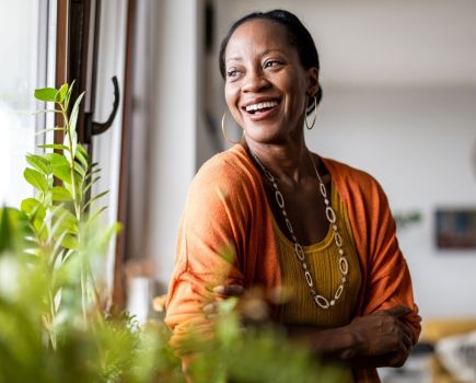 woman happy energised looking out window