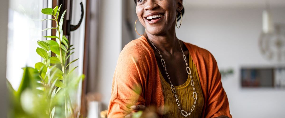 woman happy energised looking out window