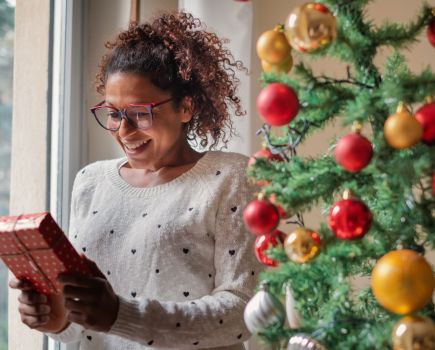 woman excited to open christmas gift