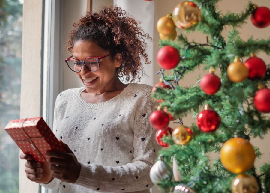 woman excited to open christmas gift
