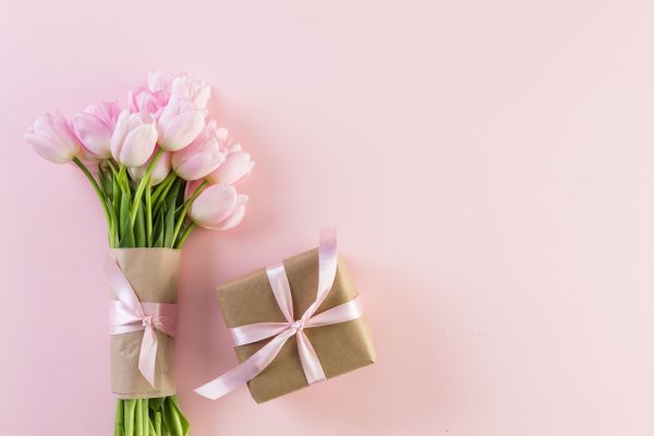 flower bouquet and wrapped present mother's day gift guide