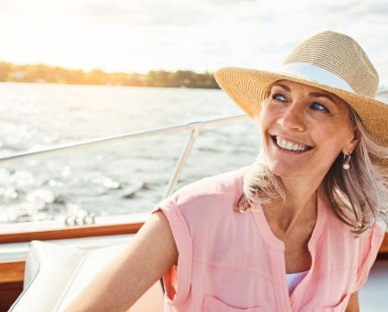 mature woman on holiday, enjoying travel experience on a boat