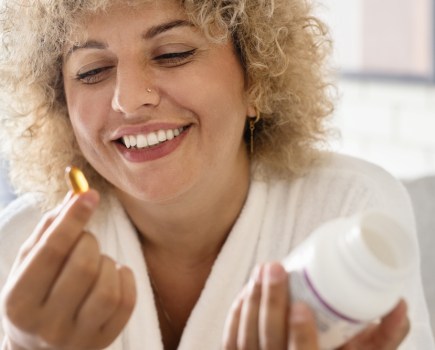 middle aged woman taking supplements for brain health