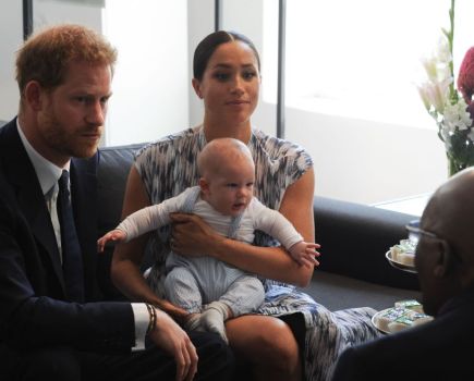 Prince Harry and his wife Meghan hold their baby son Archie as they meet with Archbishop Desmond Tutu in Capetown