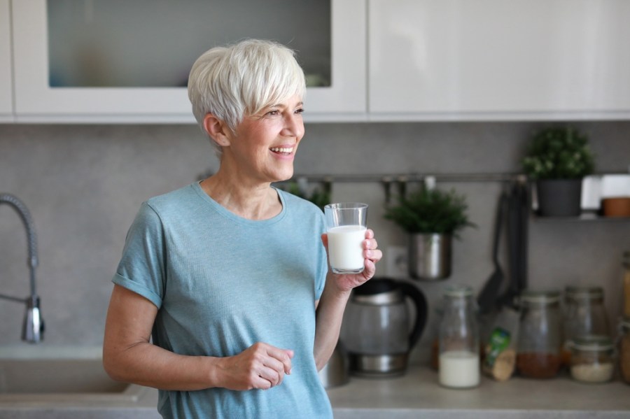 Woman in midlife drinking milk to get more protein