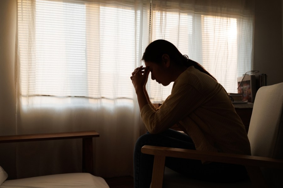 silhouetted woman looking upset