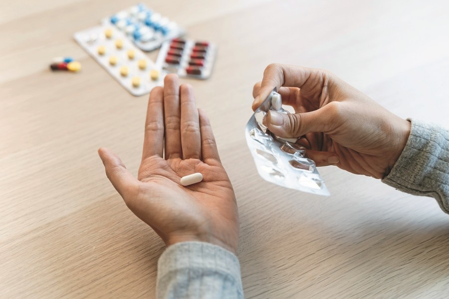 Healthcare Harmony: Close-Up Hands Holding Medication and Water Glass for Optimal Wellness, Pharmaceutical Treatment and mental health treatment