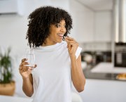 Happy,Healthy,Young,Adult,African,American,Woman,Model,Talking,Pill