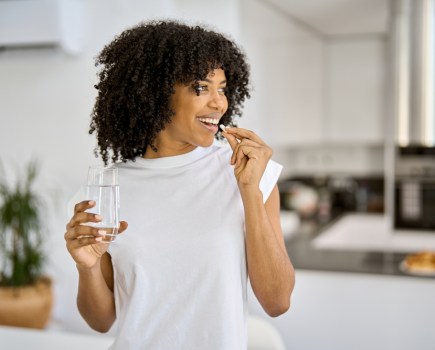 Happy,Healthy,Young,Adult,African,American,Woman,Model,Talking,Pill