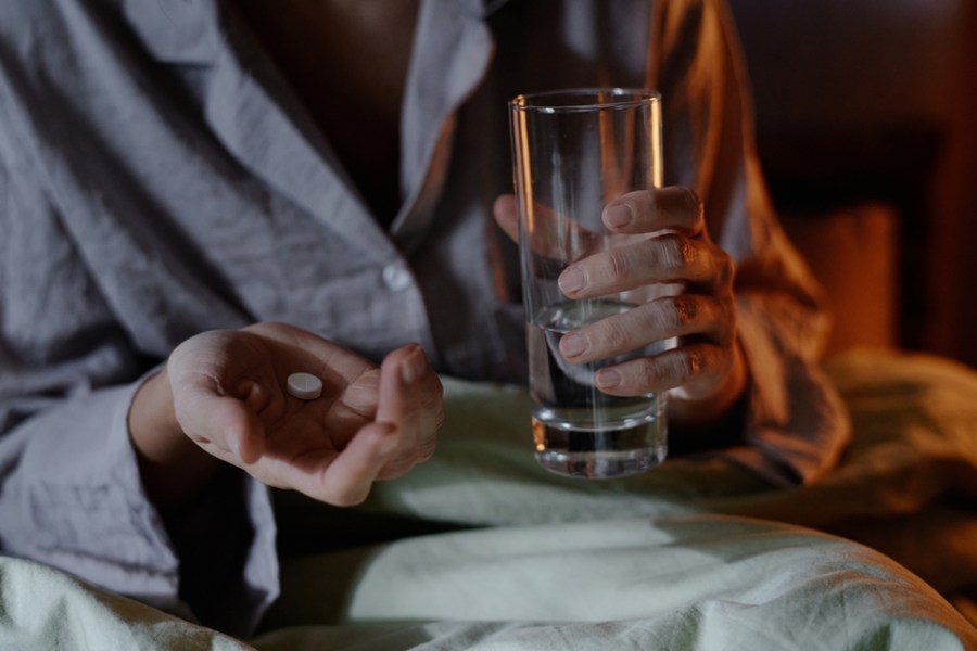 Medium,Close,Up,Of,Unrecognizable,Female,Hands,Holding,Sleeping,Pill